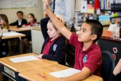 Chandler Prep students raising hands